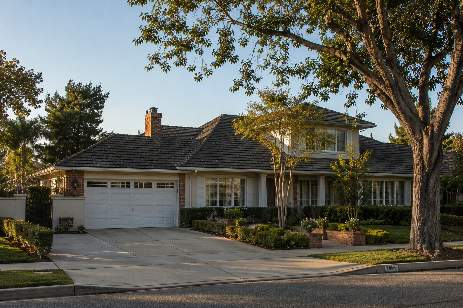 A quiet residential street in Downey, California at golden hour with jacarandas in bloom